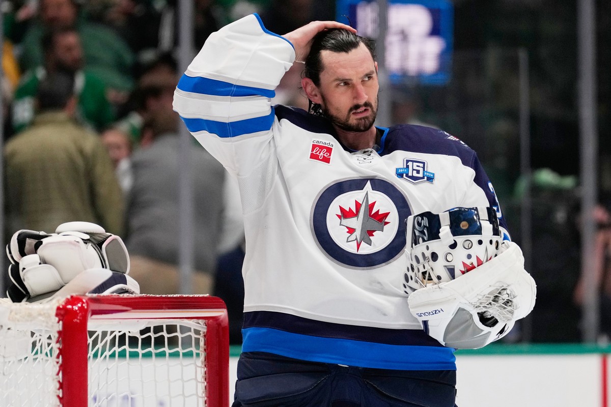 FILE - Winnipeg Jets goaltender Connor Hellebuyck stands by the net during a time out from play against the Dallas Stars in the first period of an NHL hockey game, April 2, 2026, in Dallas. (AP Photo/ ...