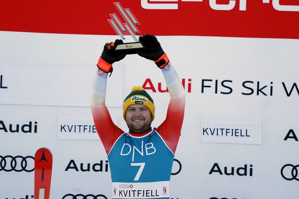 FILE - Switzerland&#039;s Niels Hintermann celebrates on the podium after winning an alpine ski, men&#039;s World Cup downhill race, in Kvitfjell, Norway, Saturday, Feb. 17, 2024. (AP Photo/Alessandro ...