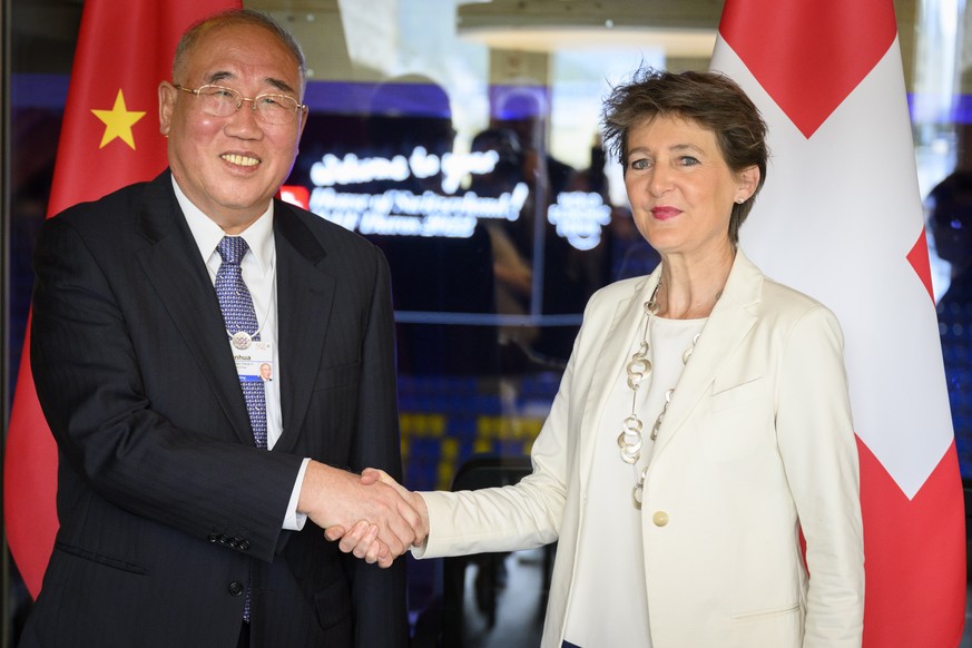 epa09965834 Switzerland&#039;s Simonetta Sommaruga (R), Federal councillor for the Environment, Transport, Energy and Communications speaks with China&#039;s Xie Zhenhua (L) Special Envoy for Climate  ...