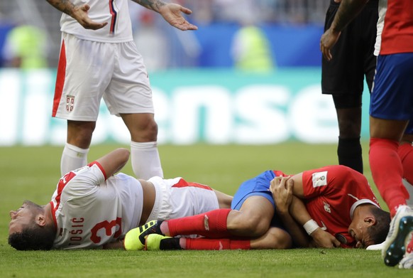 Serbia&#039;s Dusko Tosic and Costa Rica&#039;s Johnny Acosta react at the ground during the group E match between Costa Rica and Serbia at the 2018 soccer World Cup in the Samara Arena in Samara, Rus ...