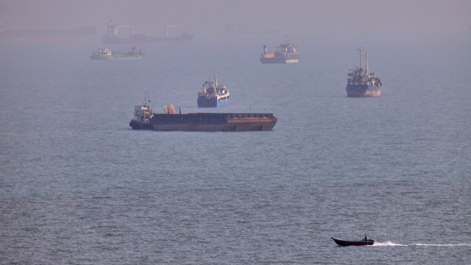 FILE - A small boat sails past cargo ships and other commercial vessels anchored in the Strait of Hormuz off Bandar Abbas, Iran, Wednesday, Aug. 5, 2026. (Amirhosein Khorgooi/ISNA via AP, File)
Iran U ...