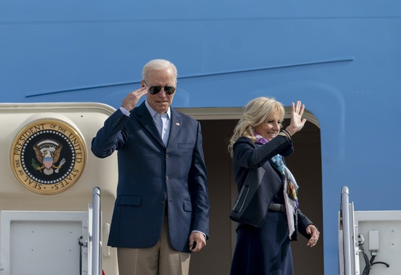 President Joe Biden returns a salute and first lady Jill Biden waves as they board Air Force One, Thursday, Oct. 28, 2021, at Andrews Air Force Base, Md. The Bidens are en route to Rome to attend the  ...