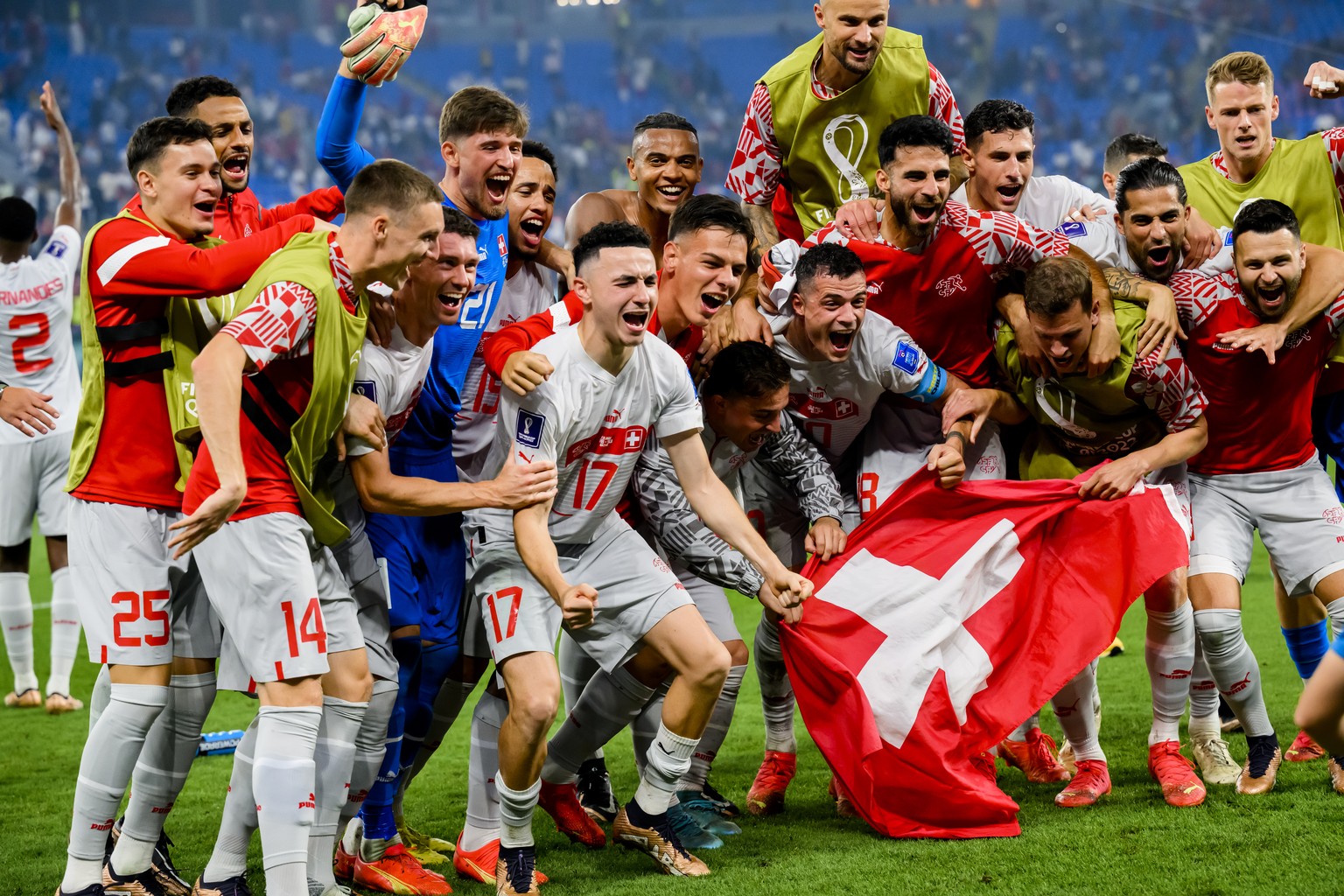 Switzerland's soccer players celebrate the victory and the qualification during the FIFA World Cup Qatar 2022 group G soccer match between Serbia and Switzerland at the Stadium 974, in Doha, Qatar, Sa ...