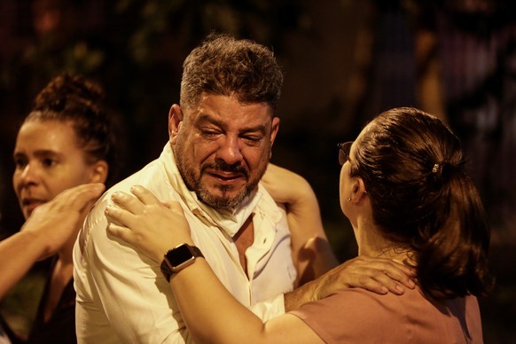 epa07838593 A man cries near a hospital that was evacuated because of a fire, in Rio de Janeiro, Brazil, 12 September 2019. A fire broke out inside Badim Hospital and forced the evacuation of admitted ...