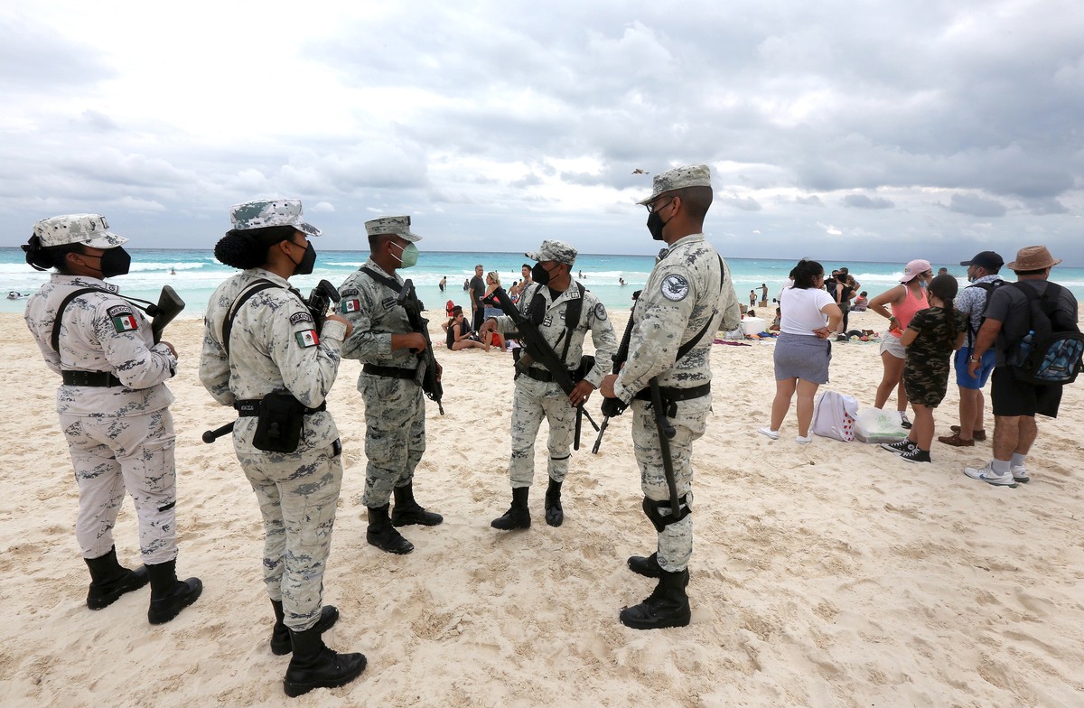 epa09617925 Personnel from the Tourist Battalion of the National Guard, guard the beaches in the resort of Cancun, Quintana Roo state, Mexico, 02 December 2021. The National Guard of Mexico guarded be ...