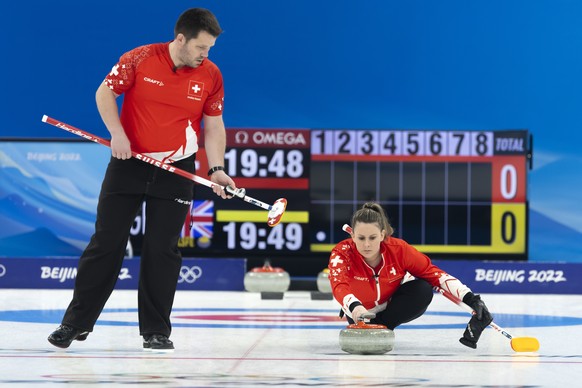 epa09724933 Martin Rios (L) and Jenny Perret of Switzerland in action during the Curling mixed doubles preliminary round game between Switzerland and Britain at the 2022 Olympic Winter Games in Beijin ...