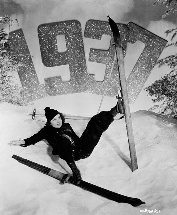 Actress Olivia de Havilland (1916-) pretending to fall over on a model ski slope in a New Years portrait, for Warner Bros Studios, 1937. (Photo via John Kobal Foundation/Getty Images)