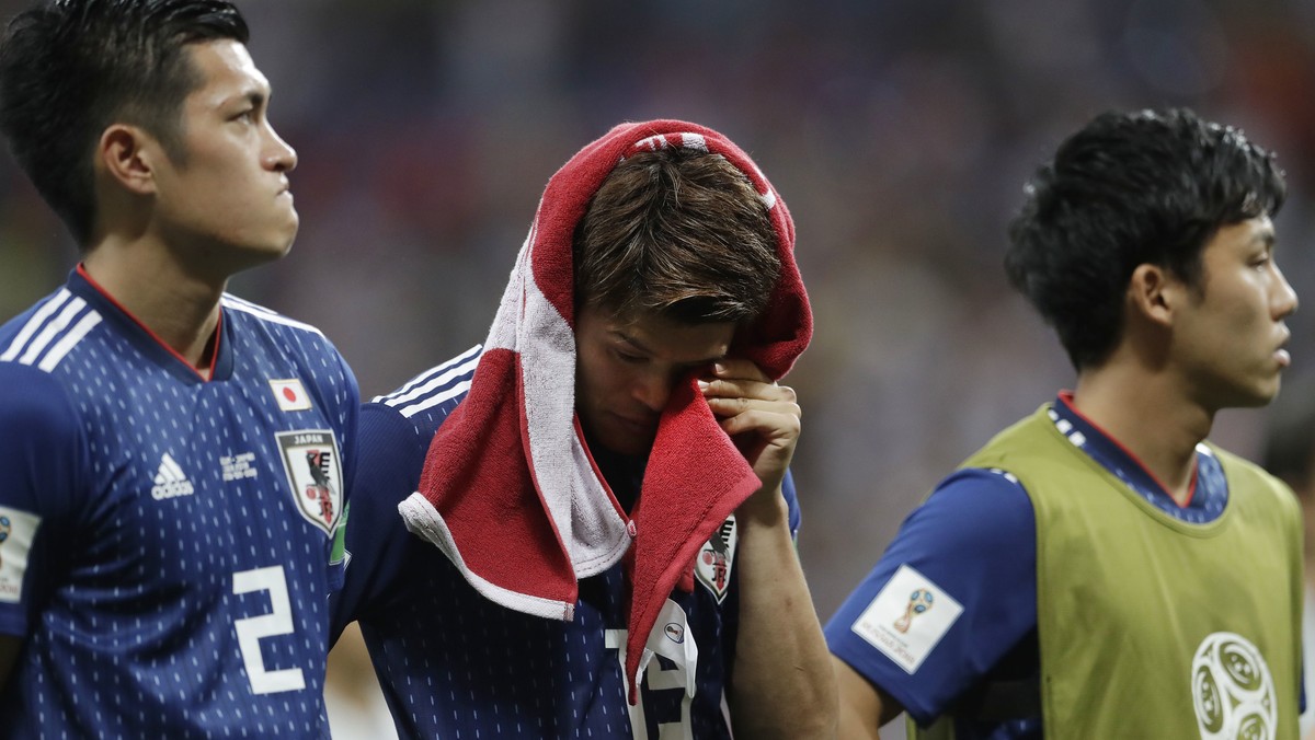 Japan's disappointed Hiroki Sakai drys a tear with a shirt after losing the round of 16 match between Belgium and Japan at the 2018 soccer World Cup in the Rostov Arena, in Rostov-on-Don, Russia, ...