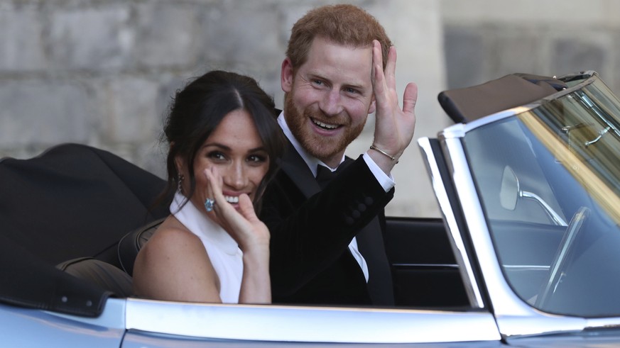 FILE - In this Saturday, May 19, 2018 file photo the newly married Duke and Duchess of Sussex, Meghan Markle and Prince Harry, leave Windsor Castle in a convertible car after their wedding in Windsor, ...