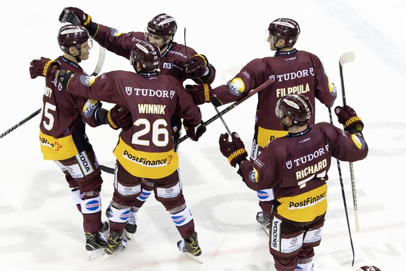 Geneve-Servette&#039;s forward Tyler Moy, left, celebrates his winner goal during the shootout session, at the National League regular season game of the Swiss Championship between Geneve-Servette HC  ...