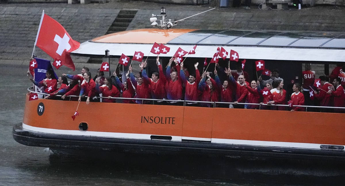 The boat carrying team Switzerland makes its way down the Seine in Paris, France, during the opening ceremony of the 2024 Summer Olympics, Friday, July 26, 2024. (AP Photo/Lindsey Wasson)