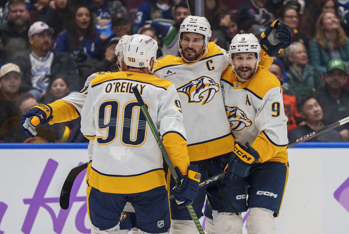 Nashville Predators' Ryan O'Reilly (90), Roman Josi (59), and Filip Forsberg (9) celebrate a goal during second period an NHL hockey match in Vancouver, on Sunday, Nov. 17, 2024. (Christophe ...