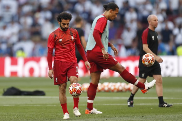 Liverpool&#039;s Mohamed Salah, left and Liverpool&#039;s Virgil Van Dijk warm up before the Champions League final soccer match between Tottenham Hotspur and Liverpool at the Wanda Metropolitano Stad ...