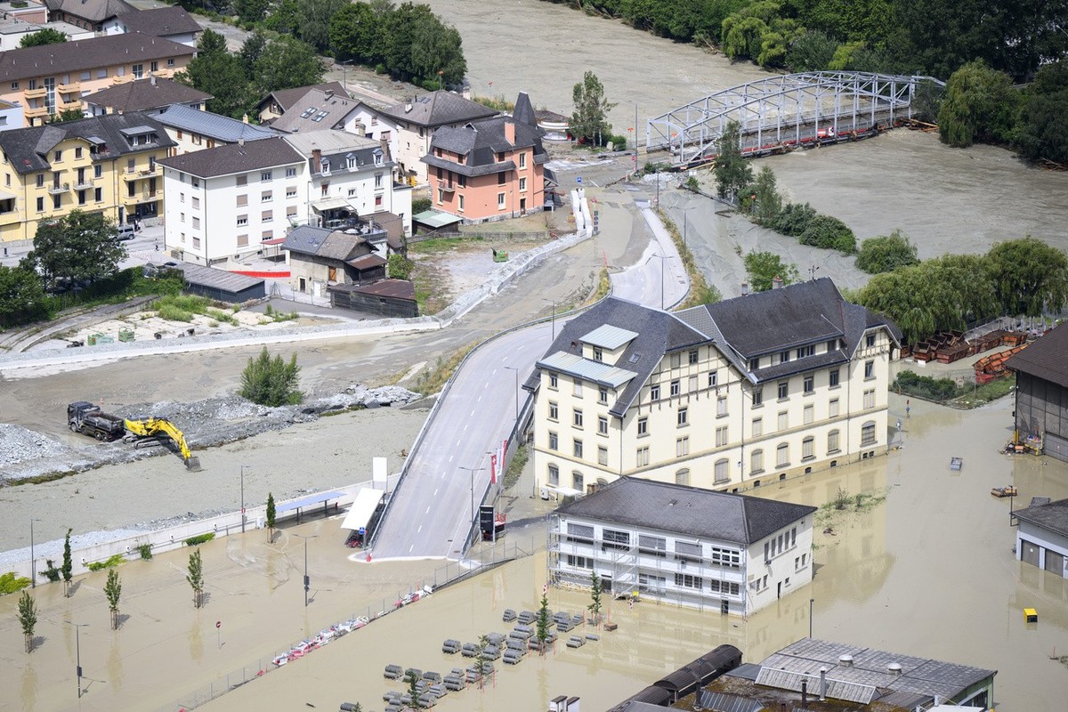 The Rhone River, right, and the Navizence river, left, are overflowing the industrial zone following the storms that caused major flooding, in Chippis, Switzerland, Sunday, June 30, 2024. (KEYSTONE/Je ...