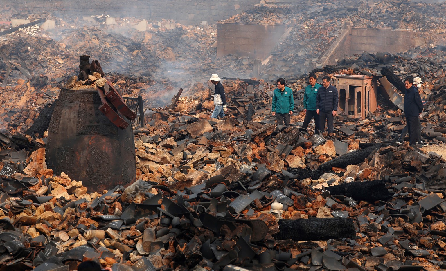 A bell is seen broken at the remains of the bell pavilion due to wildfires at Gounsa Temple in Uiseong, South Korea, Wednesday, March 26, 2025. (Kim Do-hoon/Yonhap via AP)
South Korea Wildfires