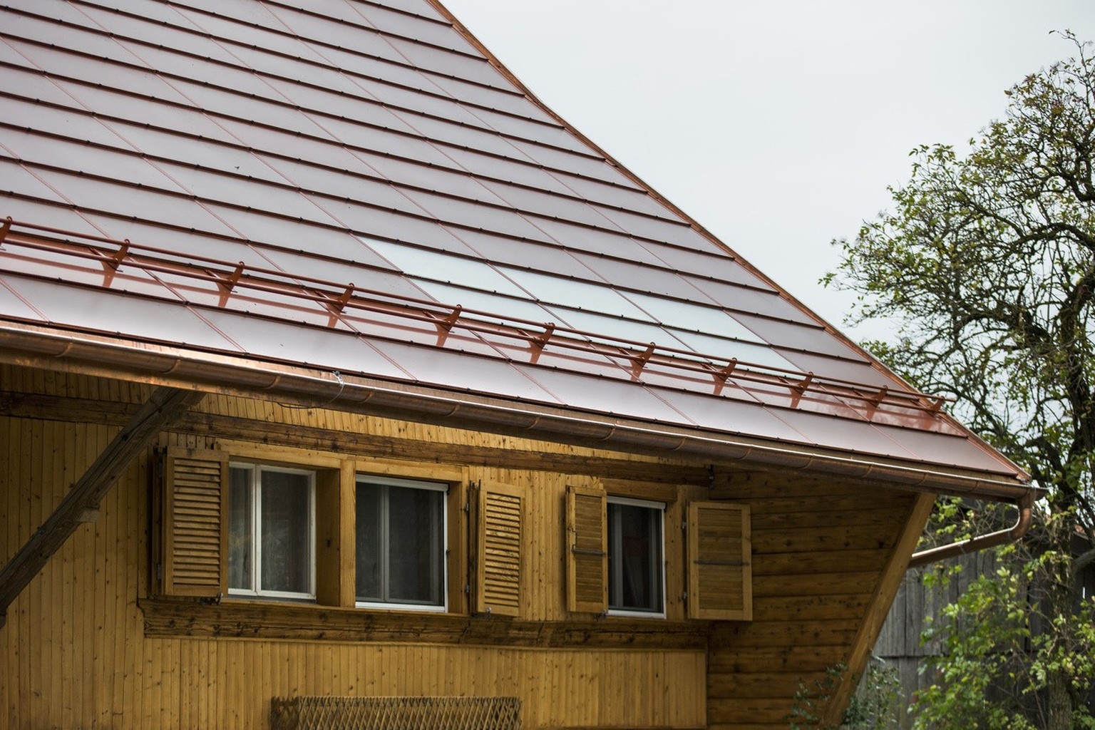 A solar installation with brick-red photovoltaic modules on the roof of the farmhouse of Alexandre Galley is presented to the media, on Monday, October 2, 2017, in Ecuvillens, Switzerland. The word fi ...