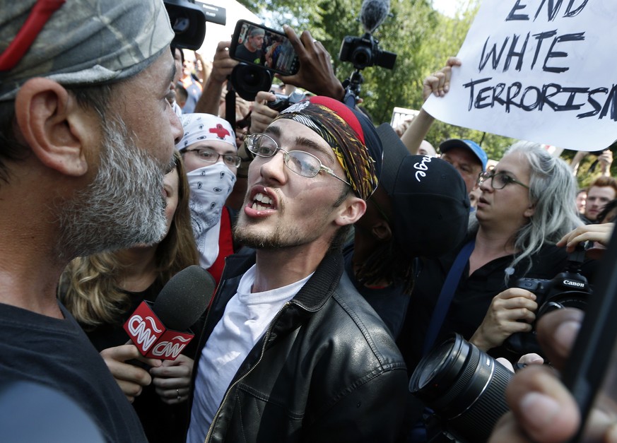 A professed supporter of President Donald Trump, center, argues with a counterprotester, left, at a &quot;Free Speech&quot; rally by conservative activists on Boston Common, Saturday, Aug. 19, 2017, i ...