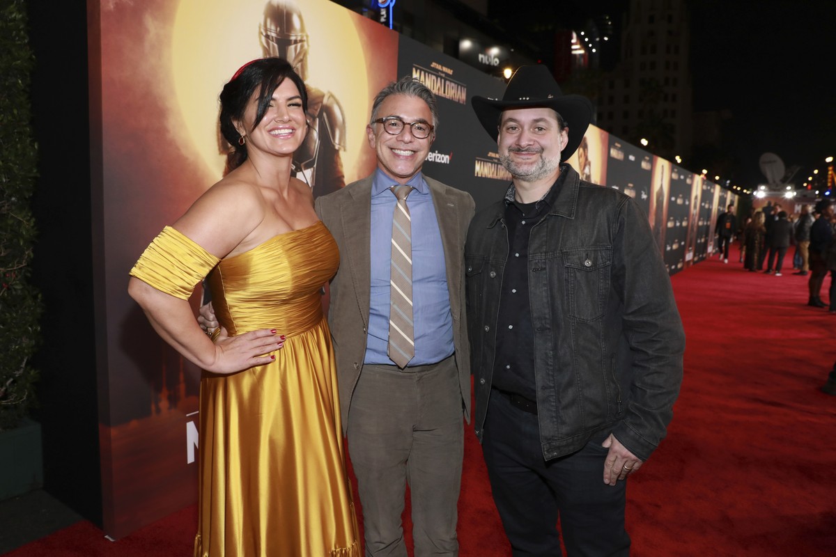 Gina Carano, from left, Ricky Strauss, and Dave Filoni attend the LA Premiere of "The Mandalorian" at the El Capitan Theatre on Wednesday, Nov. 13, 2019, in Los Angeles. (Photo by Mark Von H ...