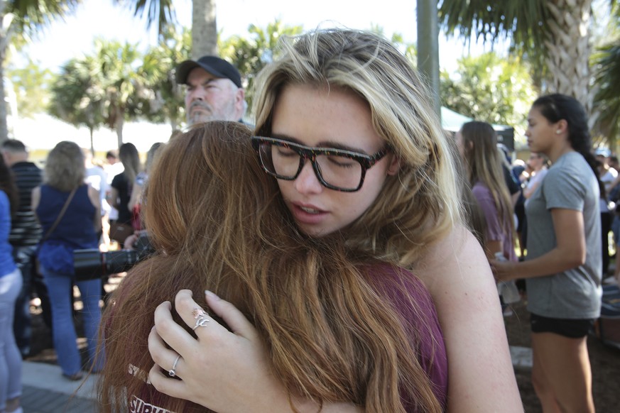 Students console each other outside Pines Trail Center where a candlelight vigil will be held, Thursday, Feb. 15, 2018, in Parkland, Fla. Nikolas Cruz is accused of opening fire Wednesday at Marjory S ...