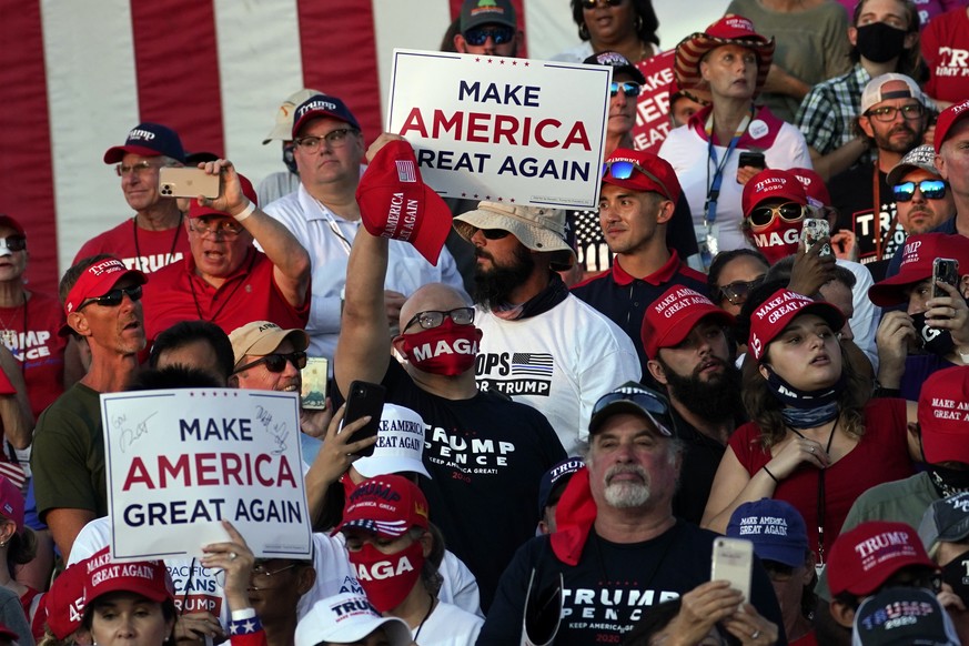 Supporters listen as President Donald Trump speaks during a campaign rally at Orlando Sanford International Airport, Monday, Oct. 12, 2020, in Sanford, Fla. (AP Photo/Evan Vucci)
Donald Trump