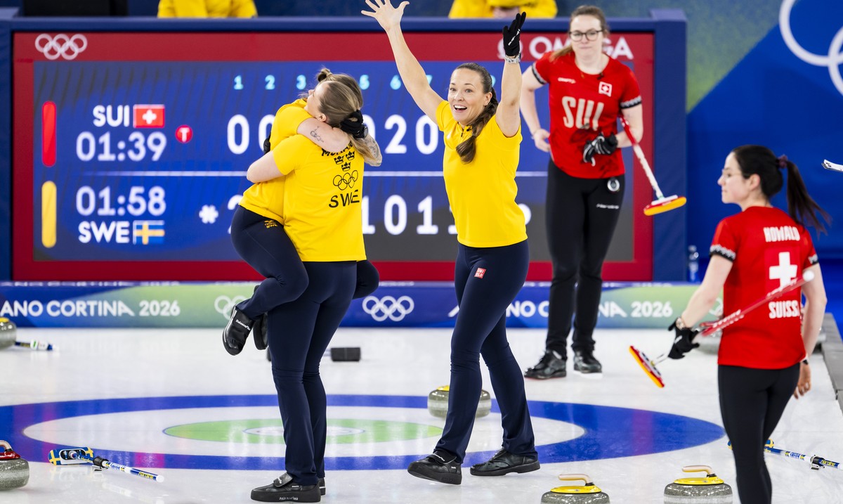 Gold medalists Sofia Mabergs, Sara McManus, Agnes Knochenhauer of Sweden, from left to right, celebrate next to Alina Paetz and Carole Howald of Switzerland during the women's curling gold medal  ...