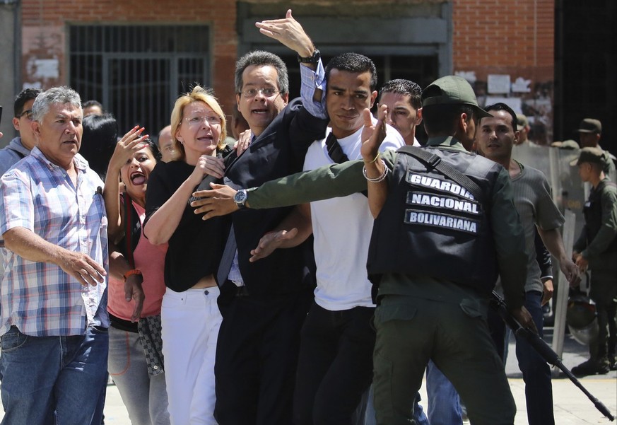 Venezuelan General Prosecutor Luisa Ortega Diaz, third left, is surrounded by loyal employees of the General Prosecutor&#039;s office, as she was barred from entering her office by security forces, ou ...