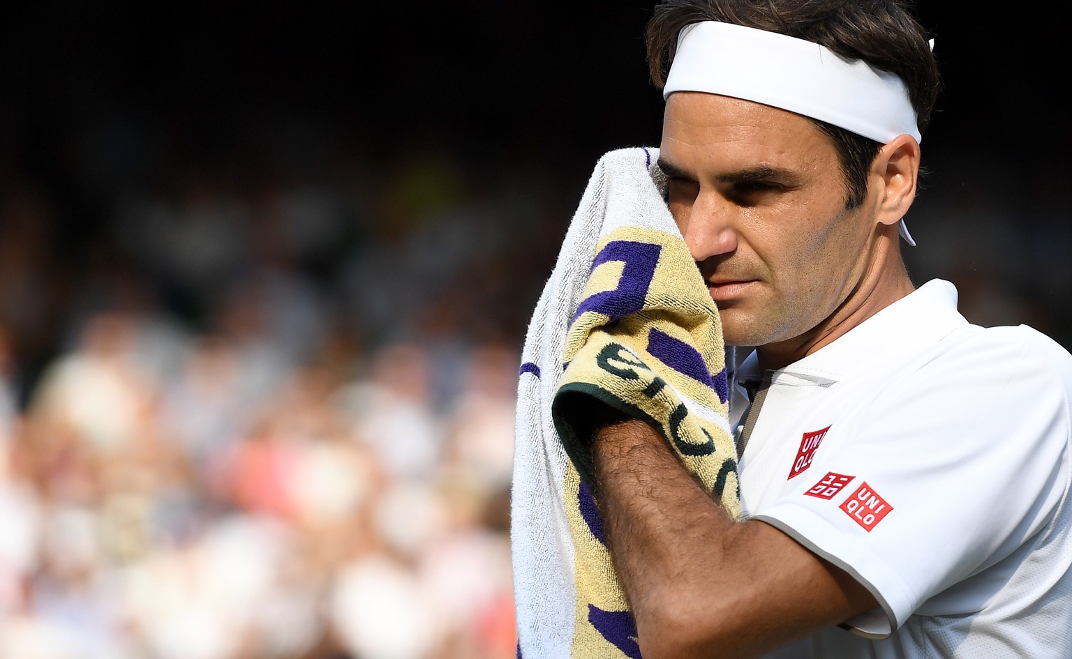 epa07708522 Roger Federer of Switzerland in action against Kei Nishikori of Japan during their quarter final match for the Wimbledon Championships at the All England Lawn Tennis Club, in London, Brita ...