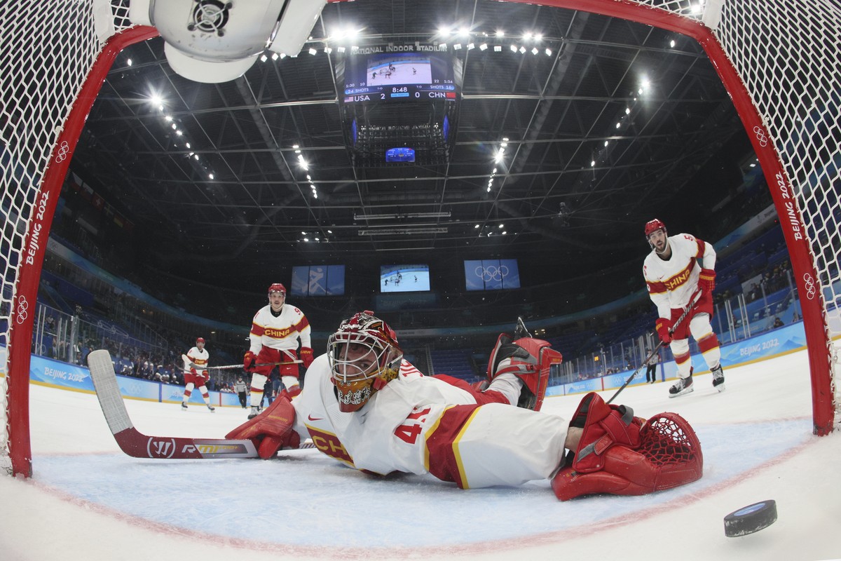 China goalkeeper Jieruimi Shimisi (Jeremy Smith) (45) reaches for the puck after United States' Brian Oneill scored a goal during a preliminary round men's hockey game at the 2022 Winter Oly ...