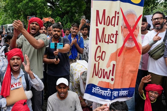 Supporters of the Cockroach Janta Party anti government slogans as they they attempt to march toward India's Parliament, demanding the resignation of the education minister, in New Delhi, India,  ...