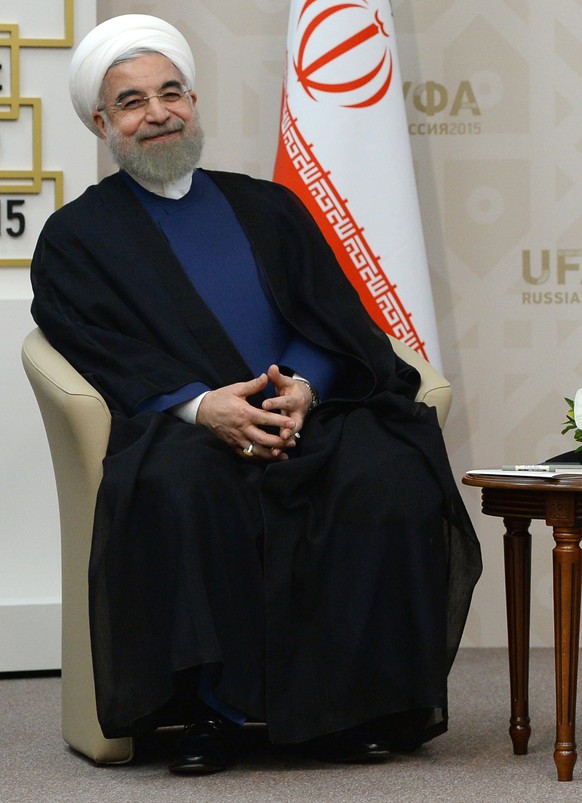 Russian President Vladimir Putin, right, shakes hands with President of the Islamic Republic of Iran Hassan Ruhani in Ufa, Russia, Thursday, July 9, 2015. (RIA Novosti Pool Photo via AP)