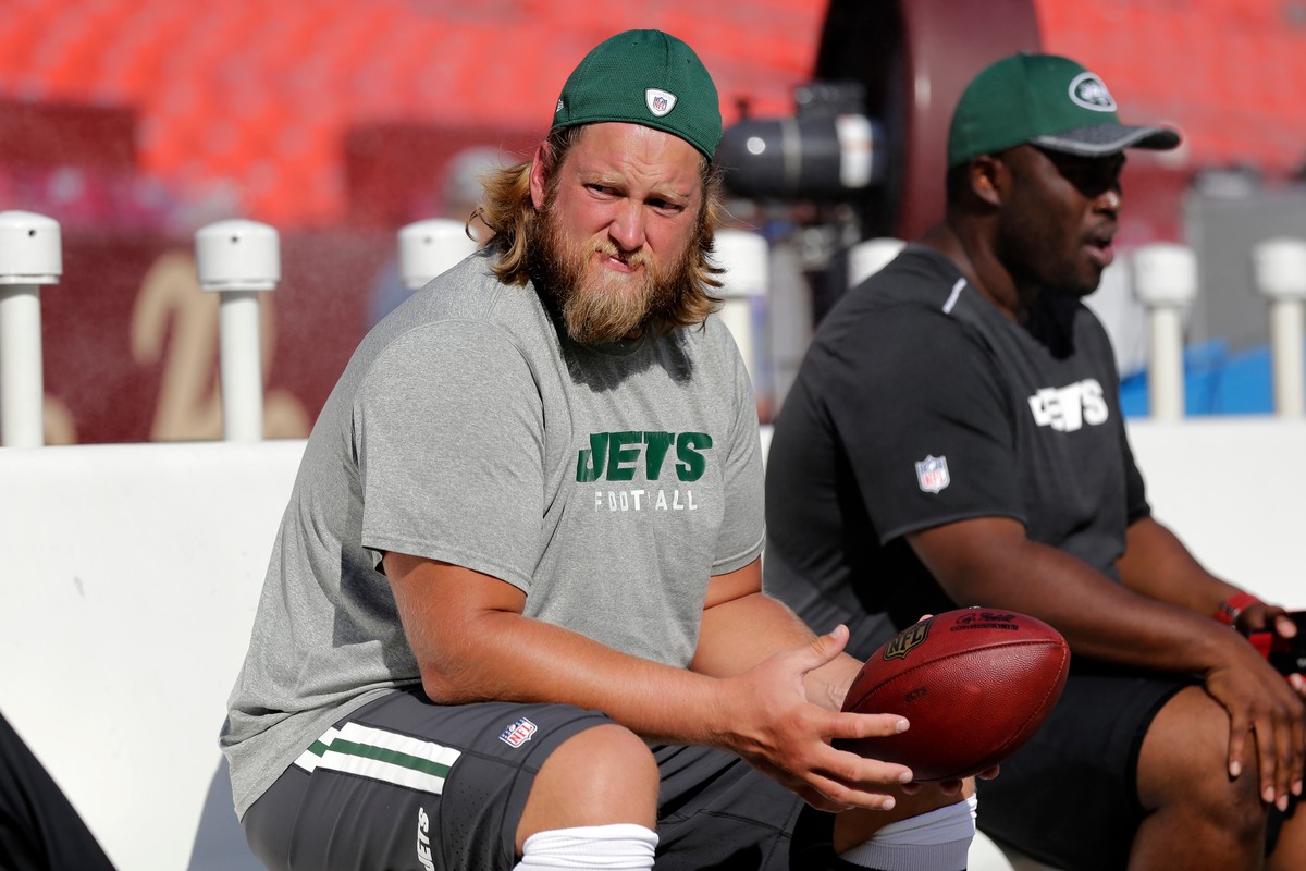 FILE - New York Jets center Nick Mangold, left, sits on the bench before an NFL preseason football game against the Washington Redskins, Friday, Aug. 19, 2016, in Landover, Md. (AP Photo/Mark Tenally, ...