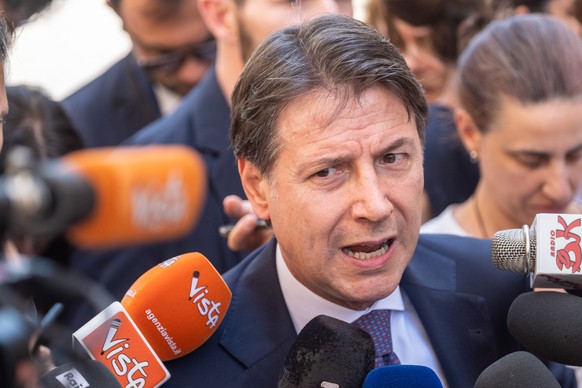 FILE - Former Italian Premier and 5-Star Movement Leader Giuseppe Conte talks to journalists outside Chigi Palace government offices in Rome, Wednesday, July 6, 2022, after meeting with Italian premie ...