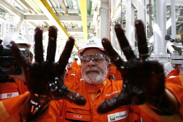 epa05549941 (FILE ) A file photo dated 28 October 2010 shows former Brazilian President Luiz Inacio Lula da Silva posing with his hands covered in oil as he takes part in the launch of the Petrobras p ...