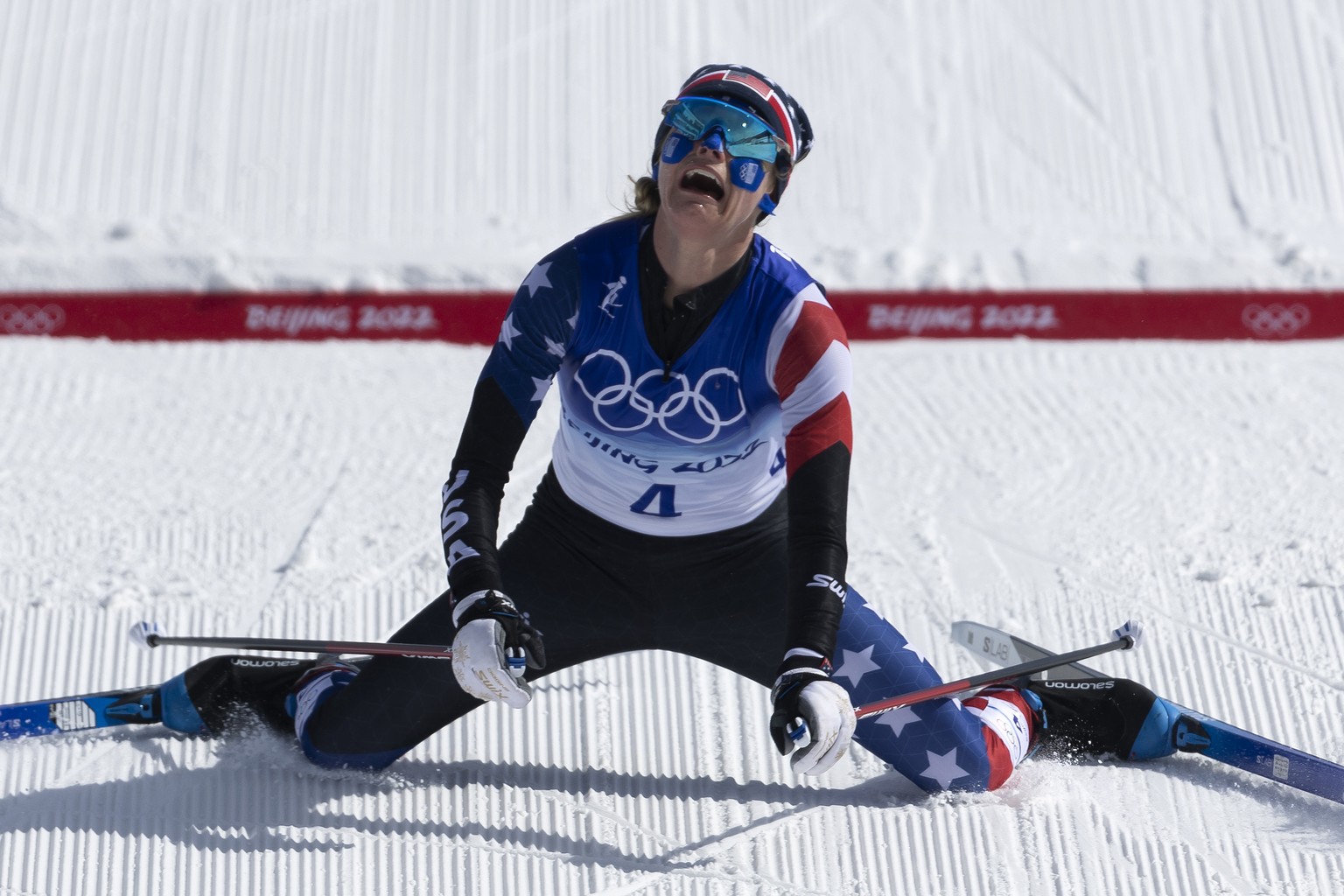 Silver medal winner Jessie Diggins of USA falls on the ground in the finish area during the women&#039;s cross-country skiing 30km Mass Start at the 2022 Winter Olympics in Zhangjiakou, China, on Sund ...