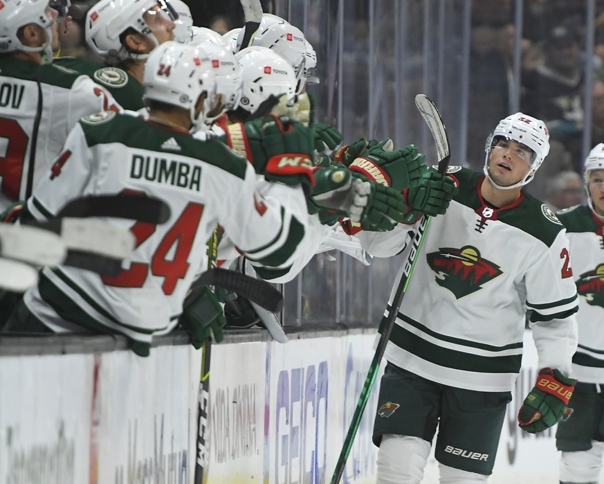 Minnesota Wild left wing Kevin Fiala (22) is congratulated by the bench after scoring a goal against the Anaheim Ducks during the second period of an NHL hockey game Friday, Oct. 15, 2021, in Anaheim, ...