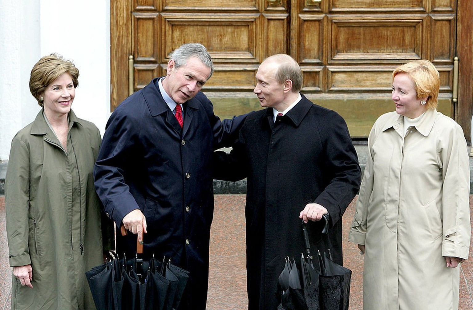 MOSCOW, RUSSIA - MAY 9: (RUSSIA OUT) U.S. President George W. Bush (2nd L) talks with Russian President Vladimir Putin (2nd R) while Ludmila Putin (R) and U.S. First Lady Laura Bush look on before the ...