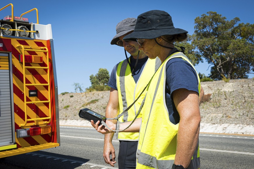 In this photo provided by the Department of Fire and Emergency Services, its members search for a radioactive capsule believed to have fallen off a truck being transported on a freight route on the ou ...