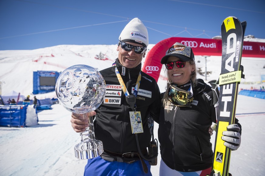 Coach Hans Flatscher amd Lara Gut of Switzerland celebrate after winning the women's Alpine Skiing World Cup Overall trophy during the podium ceremony at the FIS Alpine Ski World Cup Finals, in S ...