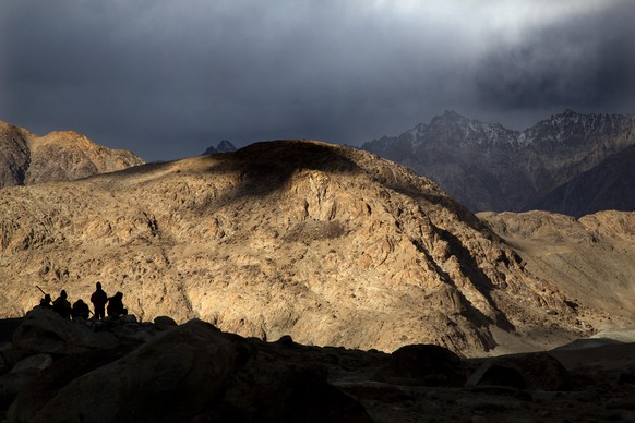 In this Sept. 14, 2018, photo, Border Roads Organization workers rest near Pangong Lake in Ladakh region, India. Indian and Chinese soldiers are in a bitter standoff in the remote and picturesque Lada ...