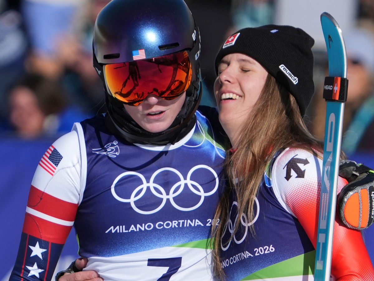 United States' Mikaela Shiffrin, left,, winner of an alpine ski, women's slalom race, is congratulated by second-placed Switzerland's Camille Rast, at the 2026 Winter Olympics, in Corti ...
