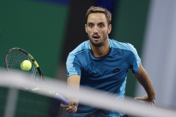 Viktor Troicki of Serbia hits a return shot against Juan Martin del Potro of Argentina during their men&#039;s singles match in the Shanghai Masters tennis tournament at Qizhong Forest Sports City Ten ...