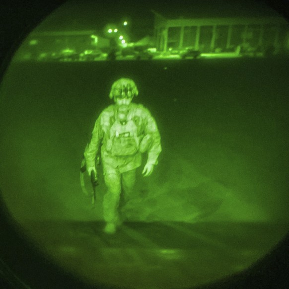 In this image made through a night vision scope and provided by U.S. Central Command, Maj. Gen. Chris Donahue, commander of the U.S. Army 82nd Airborne Division, XVIII Airborne Corps, boards a C-17 ca ...
