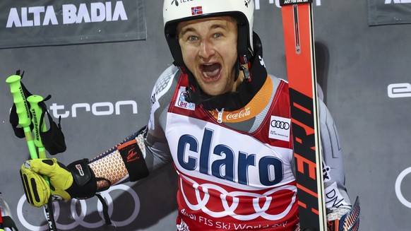 Norway's Rasmus Windingstad celebrates on the podium after winning an alpine ski, men's World Cup parallel giant slalom, in Alta Badia, Italy, Monday, Dec. 23, 2019. (AP Photo/Alessandro Tro ...