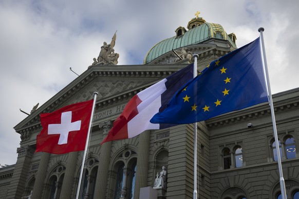 The flags of Switzerland, France and the EU wave in front of the Federal Palace, the Swiss Parliament building, in Bern, Switzerland, Wednesday, November 15, 2023. French President Emanuel Macron and  ...