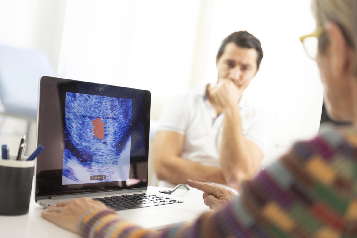 Man consulting a female doctor for prostate ultrasound examination.