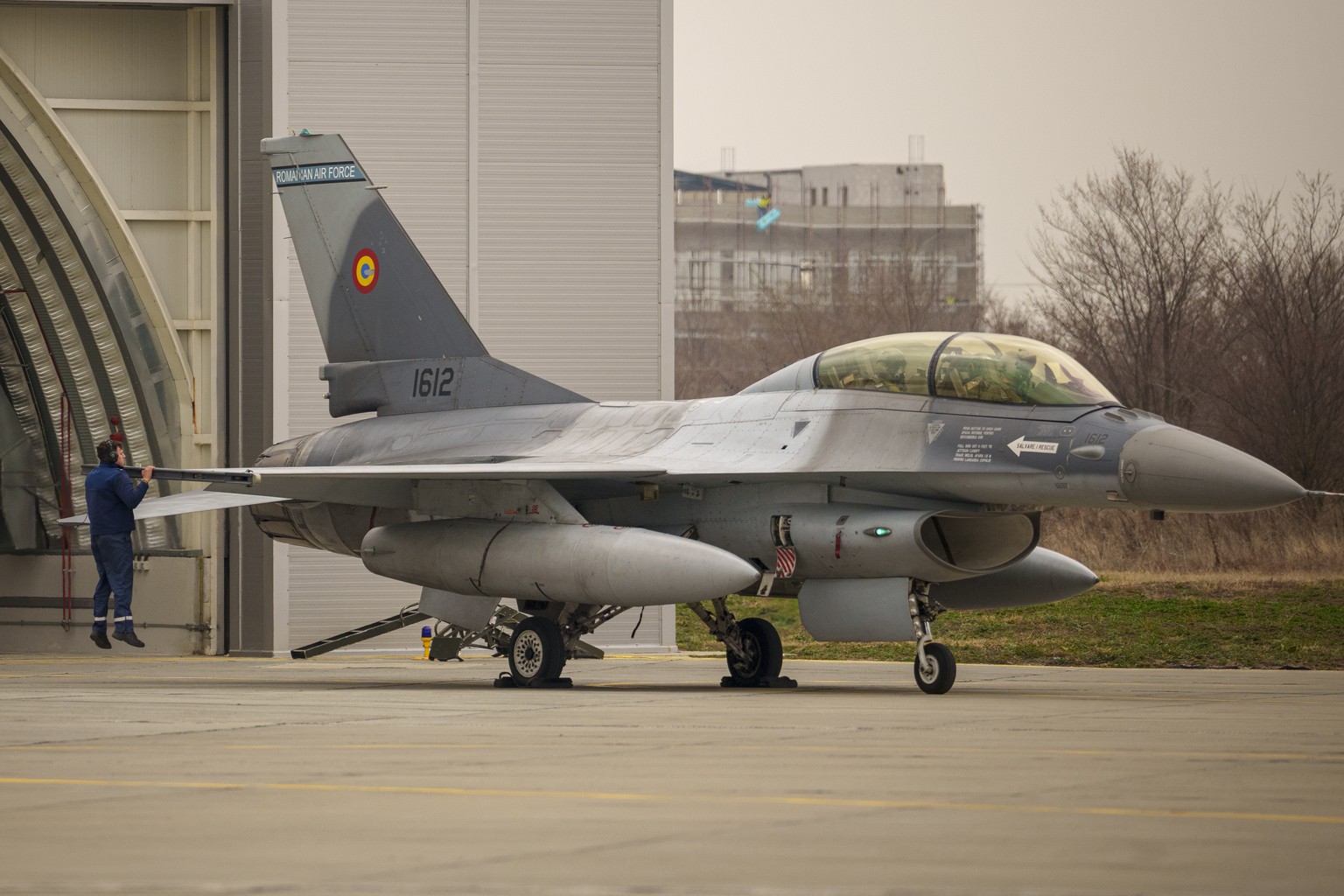 A Romanian airman makes the final checks on a F-16 military fighter jet that took part in an Air Policing exercise at the Baza 86 military air base, outside Fetesti, Romania, Wednesday, March 6, 2024. ...