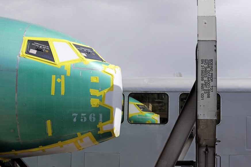 FILE - In this April 9, 2019, file photo the front of a Boeing 737 fuselage, eventually bound for Boeing's production facility in nearby Renton, Wash., sits on a flatcar rail car and is reflected in a ...