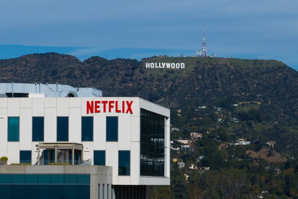 A Netflix sign is displayed atop a building in Los Angeles, Thursday, Dec. 18, 2025, with the Hollywood sign in the distance. (AP Photo/Jae C. Hong)
Warner Bros