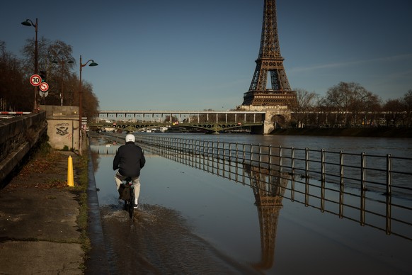 A man on a bicycle rides on the flooded banks of the Seine next to the Eiffel Tower in Paris, Wednesday Feb. 25. 2026. (AP Photo/Thomas Padilla)
France Seine