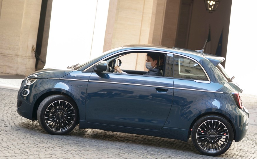 epa08525497 A handout photo made available by Chigi Palace Press Office shows Italian Prime Minister Giuseppe Conte drives the new electric Fiat 500 during its presentation in Rome, Italy, 03 July 202 ...